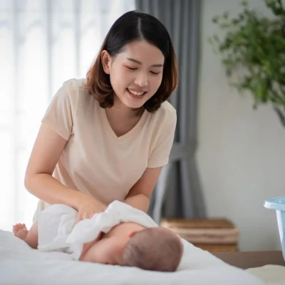 onfinement caregiver providing newborn care at home as part of a confinement service in Singapore.