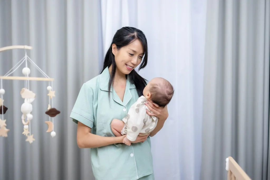 Confinement nanny caring for a newborn, supporting the family’s confinement postnatal wellness.