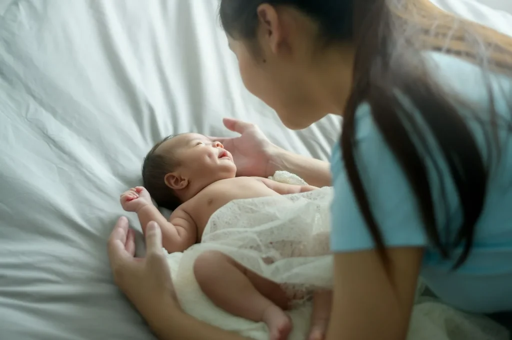 Mother bonding with her newborn, reflecting gentle confinement postnatal wellness support.
